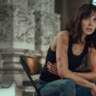 Rachel Stone sits down as she holds her injured side in Heart of Stone on Netflix