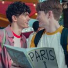 Charlie and Nick smile and look at one another in Heartstopper season 2