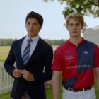 Alex and Henry stand next to each other in a field in Red, White. and Royal Blue