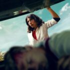 Evin Ahmad, who leads the Who is Erin Carter cast as the titular Erin Carter is pictured from inside the boot of a car, which has a man