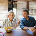 Dan Buettner talks to an elderly man in one of the world's Blue Zones - still taken from upcoming Netflix series Secrets of the Blue Zones