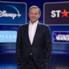 Bob Iger posing in front of several screens displaying various Disney owned properties