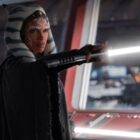 Rosario Dawson holding a lightsaber as Ahsoka in the Ahsoka series.