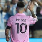Inter Milan forward Lionel Messi waving at fans with his back to camera, wearing an Inter Miami shirt with his surname and number 10 printed on the back.