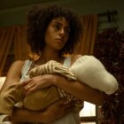 Emma holds baby Brian, looking tired and suspicious, in The Changeling.