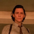 Close up of Loki standing in the door of a room in the TVA.
