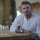 David Beckham sits stony faced at a table in his Netflix docuseries