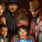 Haunted Mansion Disney+ poster featuring LaKeith Stanfield, Tiffany Haddish, Owen Wilson, Danny DeVito, Rosario Dawson, Chase W. Dillon standing around a crystal ball