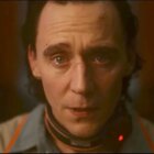 Loki stares into the camera with tears welling up in his eyes. He
