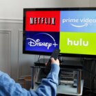 In this photo illustration, the logos of media service providers, Netflix, Amazon Prime Video, Disney + and Hulu are displayed on the screen of a television.