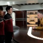 Scene from the T.V. show Star Trek: Strange New Worlds. Here we see 2 younger officers talking to an older officer.