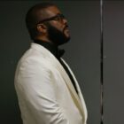 Tyler Perry standing next to a door in Maxine&rsquo;s Baby: The Tyler Perry Story