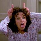 Elaine makes mocking devil horns on her head in Seinfeld.
