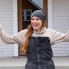 As seen on D+ Risky Business, Mina Starsiak Hawk poses for a portrait in front of the historic Sander’s House.