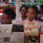 Erica Sinclair and her friends stand at the retail cash register for scoops ahoy in Netflix show stranger things 