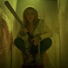 Jamie Hughes hides in a bathroom stall in Prime Video horror movie Totally Killer