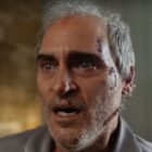 Joaquin Phoenix looks past the camera in horror in a still from Beau is Afraid