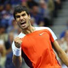 Tennis player Carlos Alcaraz of Spain, wearing a red Nike top, pumps his fist in celebration ahead of his debut at the ATP Finals 2023