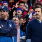 Coach Beard and Ted look at someone off-camera in Ted Lasso on Apple TV Plus