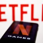 A smartphone with the Netflix Games logo in front of the words Netflix