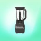 A 72-ounce Ninja Professional blender against a green background.