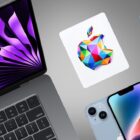 A MacBook, iPhone, Apple Watch and Apple gift box on a grey background
