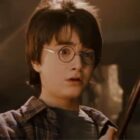 Harry Potter holding his wand for the first time