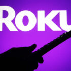 UKRAINE - 2021/07/04: In this photo illustration a Roku logo is seen on a screen with a silhouette of a hand holding a tv remote. (Photo Illustration by Pavlo Gonchar/SOPA Images/LightRocket via Getty Images)
