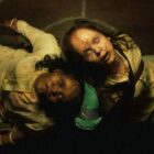 Two girls in The Exorcist Believer look up at the sky, with carvings on their flesh and dirty, bloated faces