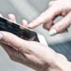 Closeup of woman's hand holding white iPhone