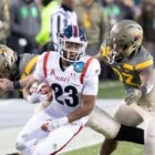  Devean Washington #23 of the Navy Midshipmen fights off the Army in the Army vs Navy live stream