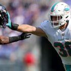Alec Ingold (R) hands off Chuck Clark (L) ahead of the Dolphins vs Ravens live stream