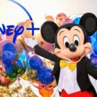 Mickey Mouse gesturing at Disney+ logo with balloons