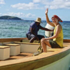 Emily Flippen waves while sitting on a boat in 