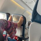 Woman Using Toes to Change TV Channels on Plane