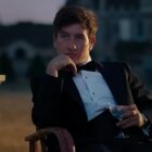 Barry Keoghan in a tuxedo with a cocktail drink