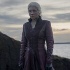 Queen Rhaenyra stands stoically alone on a shoreline in House of the Dragon season 2