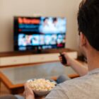 Man-Watching-TV-and-Eating-Popcorn-at-Home