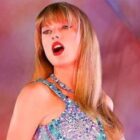 Taylor Swift performing on stage in Taylor Swift: The Eras Tour concert movie 
