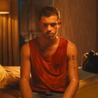A young man sits on the edge of his bed looking perturbed in "I Am Jonas" 