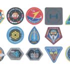 13 space mission patches sit on a white background
