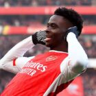 Bukayo Saka of Arsenal celebrates after scoring prior to the PSV vs Arsenal Champion
