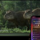 Two dinosaurs on a large television, with a hand holding an iPhone sending the video to the television with AirPlay