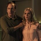 Saul and Kim look shocked as they stand in a dimly lit room in Better Call Saul