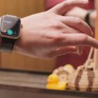 A person uses a Mudra Band Apple Watch strap to control their Apple Watch.