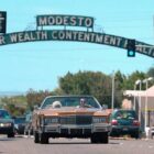 Hip-hop artist Macklemore and his grandmother, Helen Schott, shown driving near the Modesto arch on I street in a still from his music video “Glorious.” The city of Modesto in California is the backdrop for the video, which shows Macklemore spending the day with his grandmother at various locations around town. It was shot over a few days over mid-June.