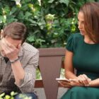 Michael Graziadei and Christel Khalil as Daniel and Lily on a park bench in The Young and the Restless