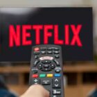 Netflix on TV with remote control in foreground