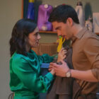 A man and a woman in a laundry room, looking awkwardly/romantically at each other.