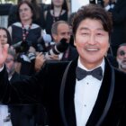 Song Kang-ho waves to   the camera at Cannes.